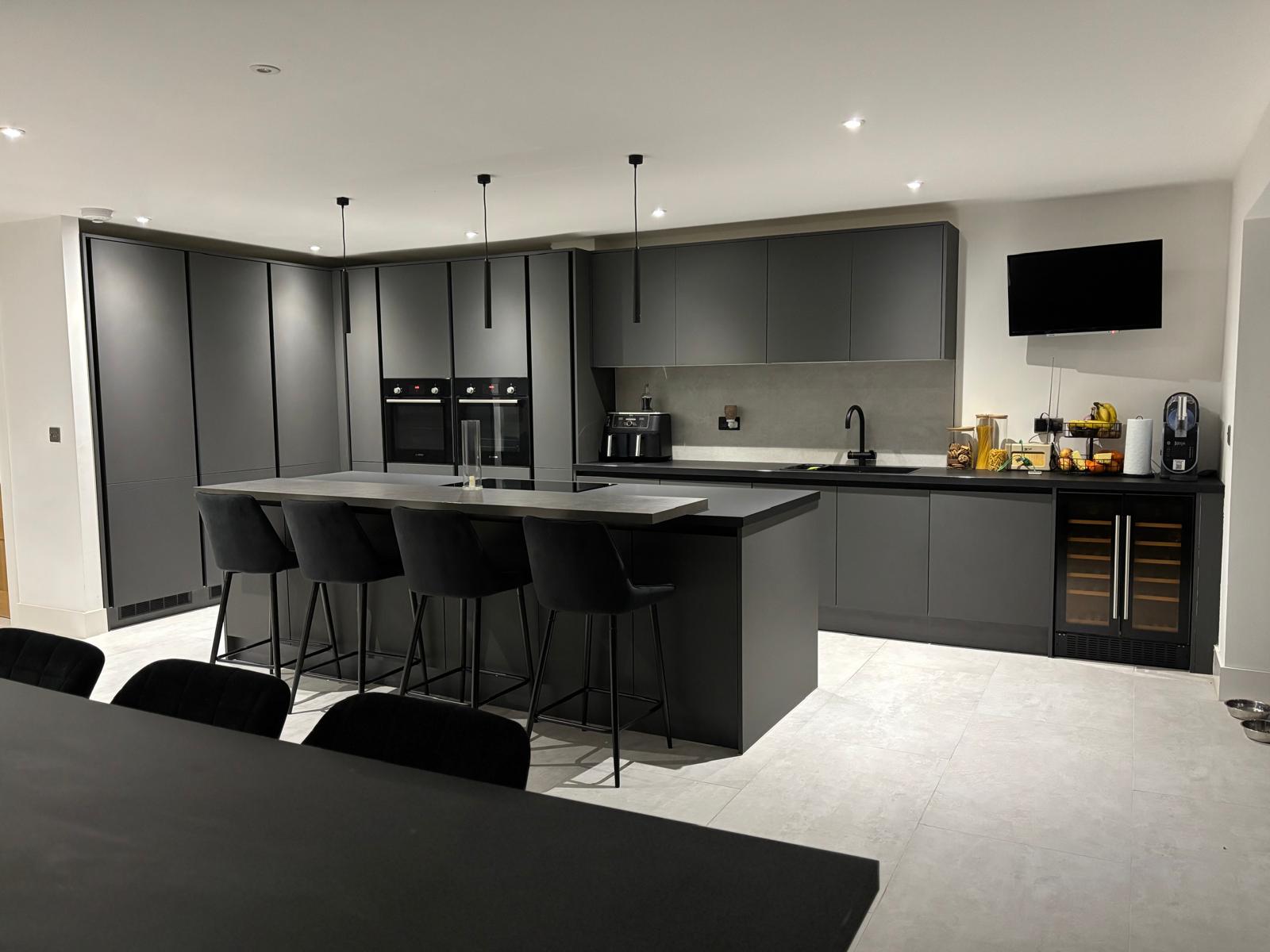 Modern fitted kitchen with dark cabinetry and island