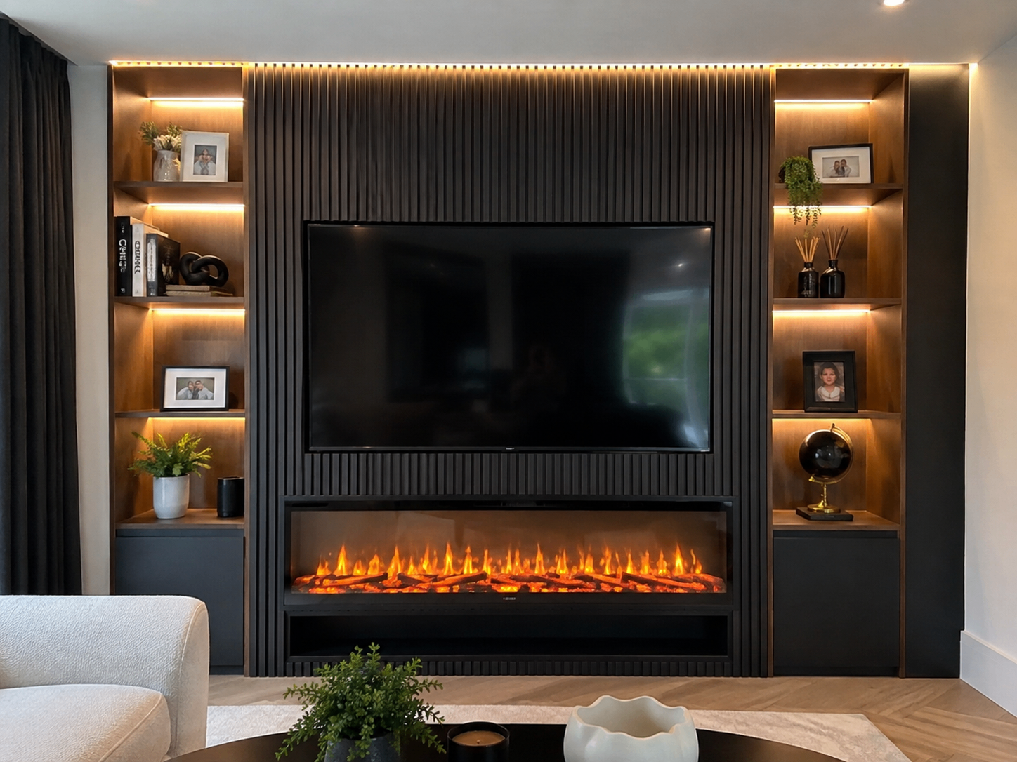 Completed media wall with fitted shelving and fireplace